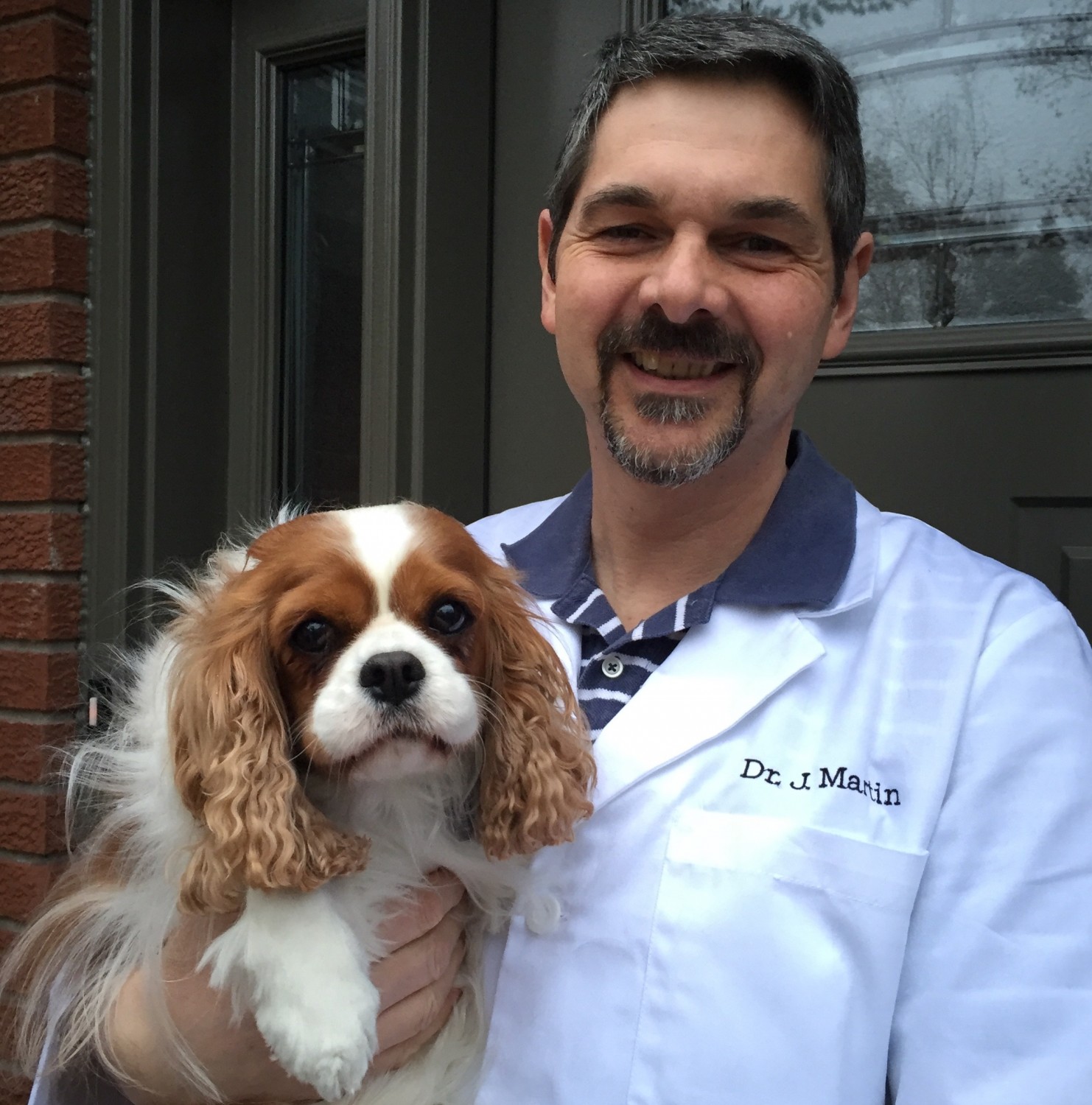 Dr. Martin holding dog